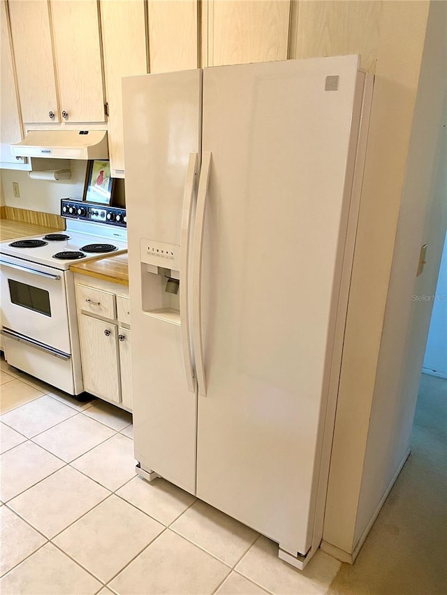 kitchen with white appliances and light tile patterned flooring