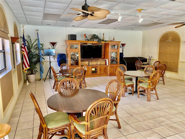 tiled dining room featuring ceiling fan and a paneled ceiling