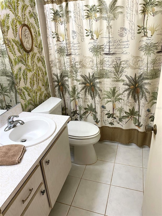 bathroom featuring tile patterned floors, toilet, and vanity