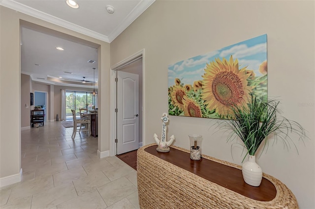 corridor featuring light tile patterned flooring and ornamental molding