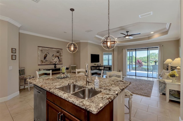 kitchen with pendant lighting, dishwasher, light tile patterned floors, and sink