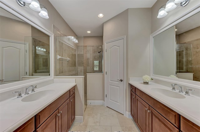 bathroom featuring tile patterned floors, vanity, and a shower with shower door