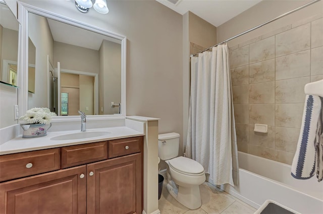 full bathroom featuring tile patterned floors, shower / bath combination with curtain, toilet, and vanity