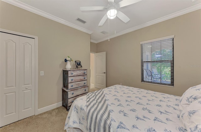 carpeted bedroom featuring ceiling fan, a closet, and ornamental molding