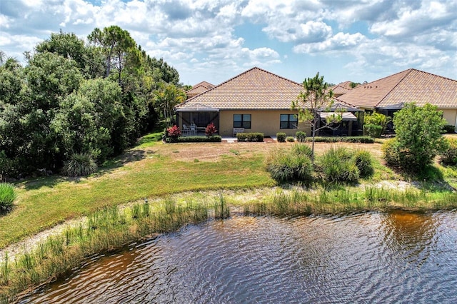 back of property featuring a water view