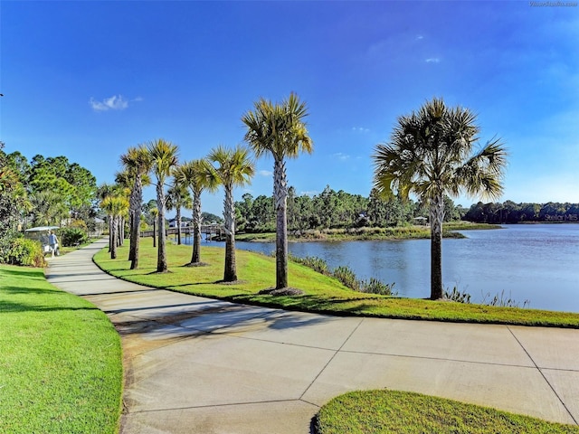 view of community featuring a water view and a lawn