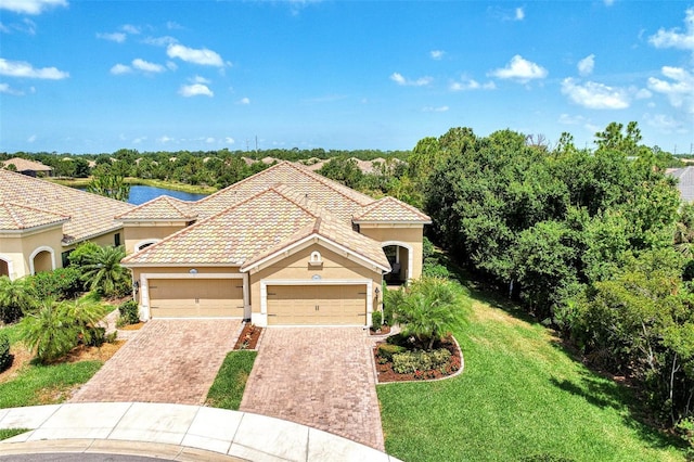 mediterranean / spanish house with a front yard and a garage