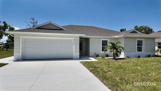 ranch-style house with a garage and a front yard