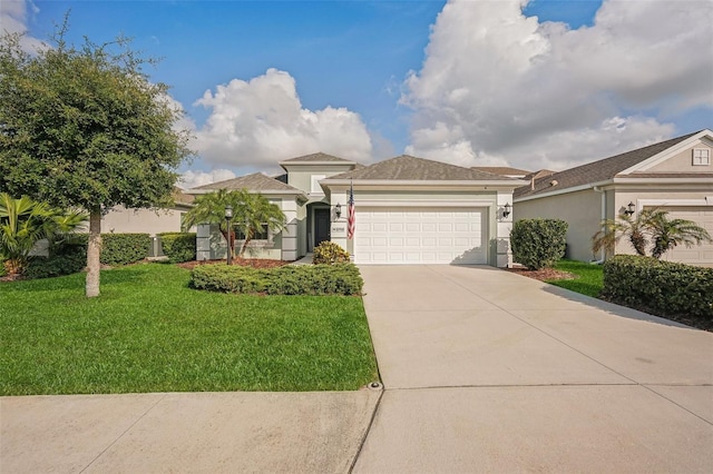 view of front of house featuring a front lawn and a garage