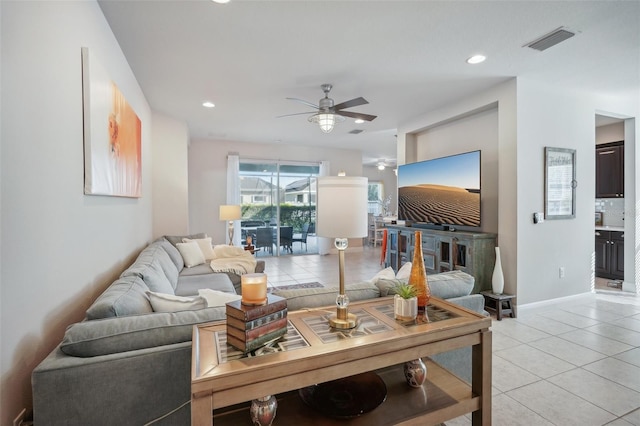 tiled living room with ceiling fan