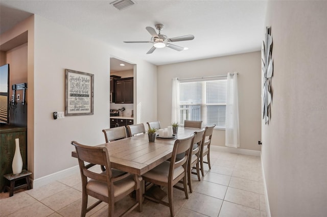 tiled dining room featuring ceiling fan