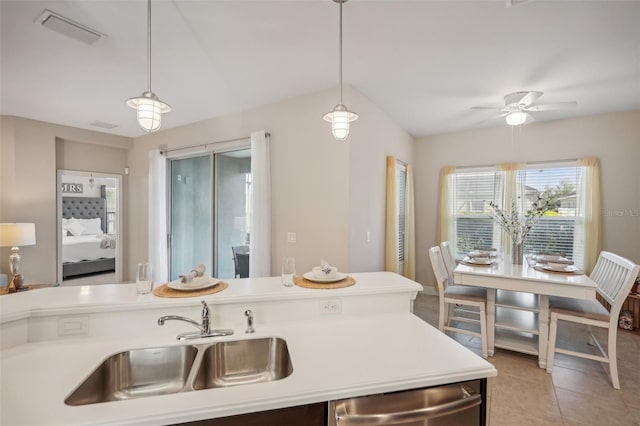 kitchen featuring hanging light fixtures, sink, ceiling fan, and light tile floors