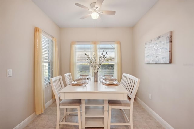 dining space featuring ceiling fan and light tile floors