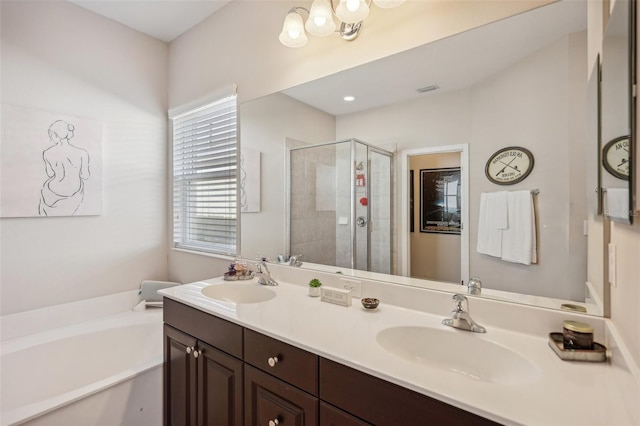 bathroom featuring dual sinks, plus walk in shower, and large vanity