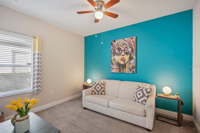 carpeted living room with ceiling fan