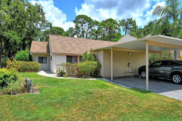 ranch-style home featuring a front yard and a carport