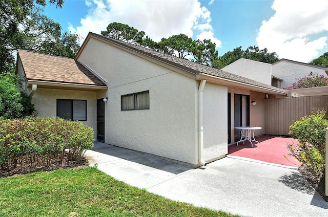 view of property exterior with a patio area