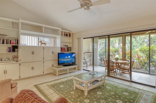 living room with ceiling fan, light tile patterned flooring, and vaulted ceiling