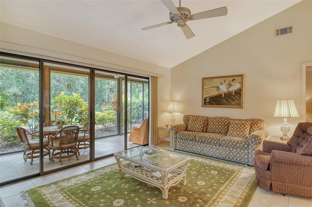 tiled living room featuring ceiling fan and vaulted ceiling