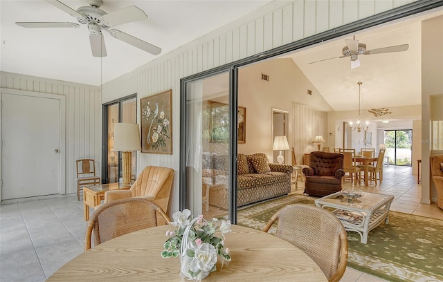 sunroom / solarium with ceiling fan with notable chandelier and lofted ceiling