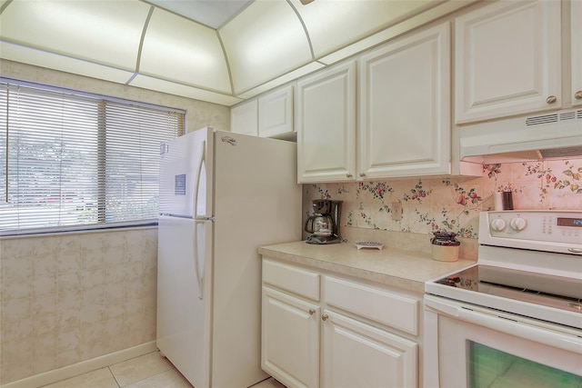 kitchen with light tile patterned floors, white appliances, and ventilation hood