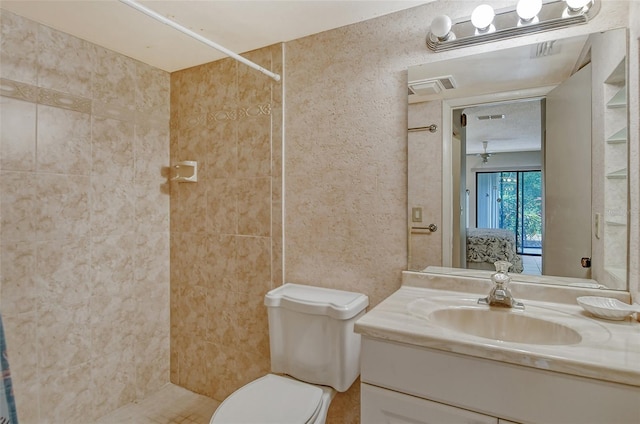 bathroom with ceiling fan, toilet, vanity, and walk in shower