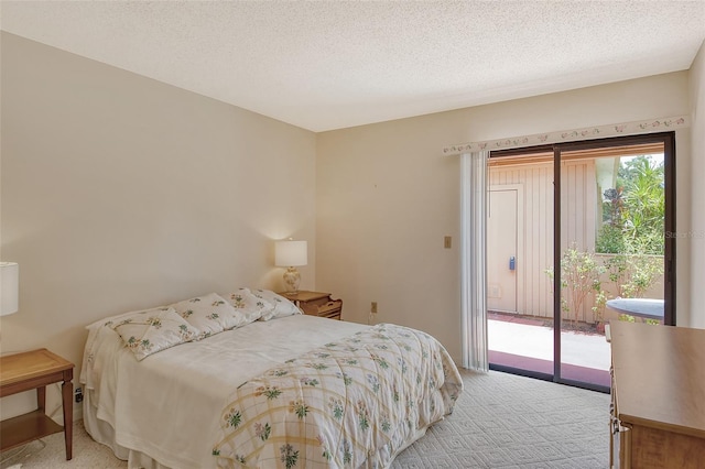 bedroom with light carpet, a textured ceiling, and access to outside