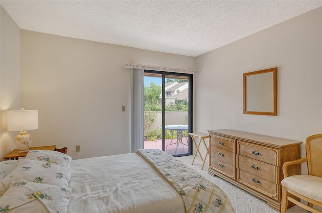 bedroom featuring access to exterior and a textured ceiling