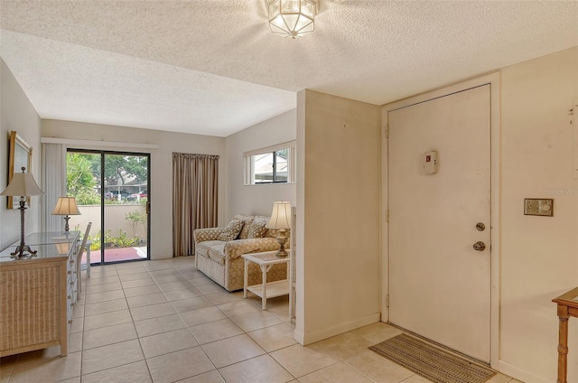 tiled foyer featuring a textured ceiling