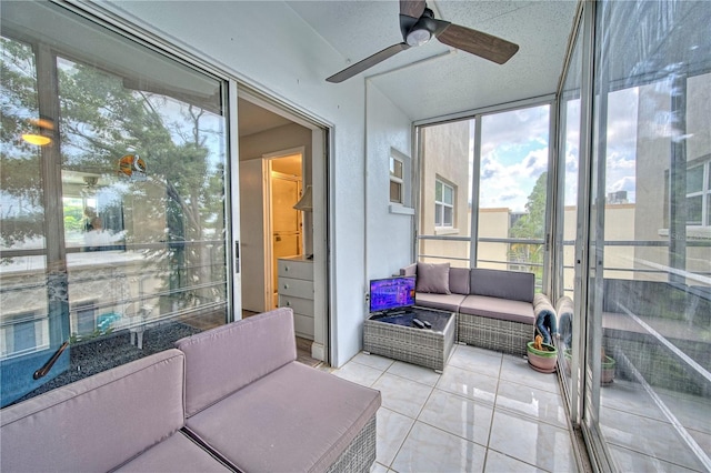 sunroom / solarium featuring ceiling fan