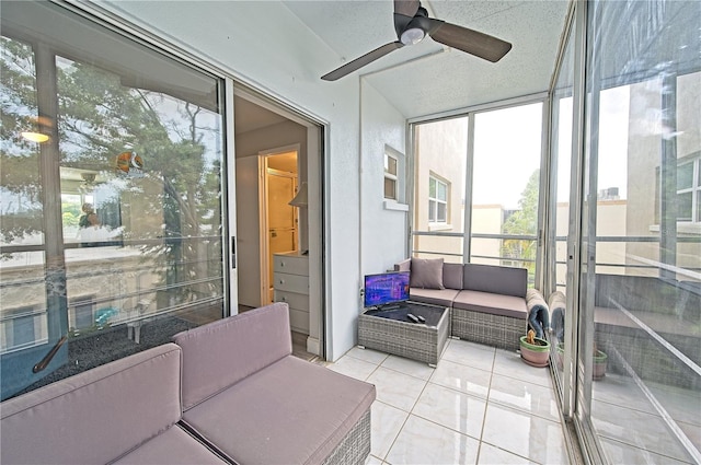 sunroom / solarium featuring a ceiling fan