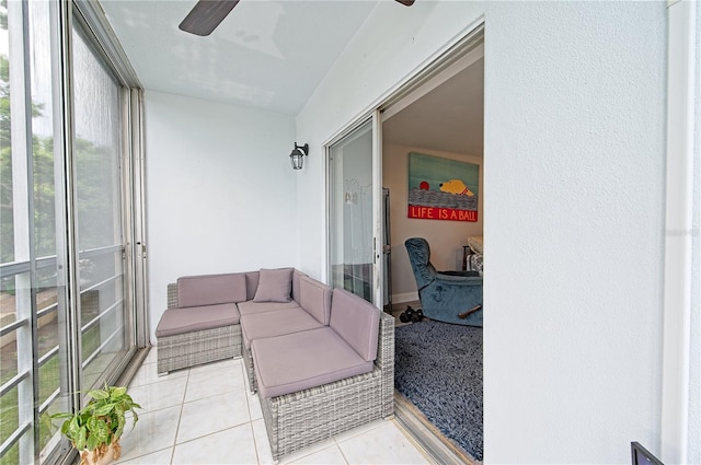 sunroom / solarium featuring a ceiling fan