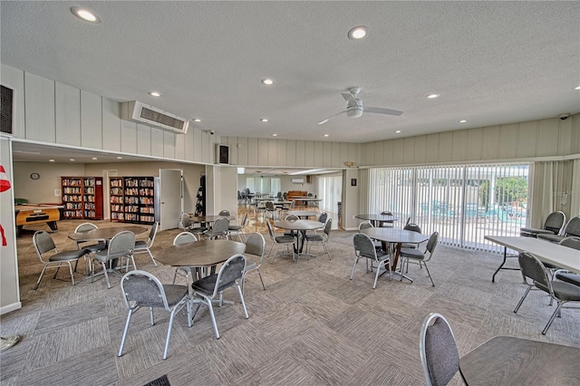 dining area featuring light carpet, a textured ceiling, and recessed lighting