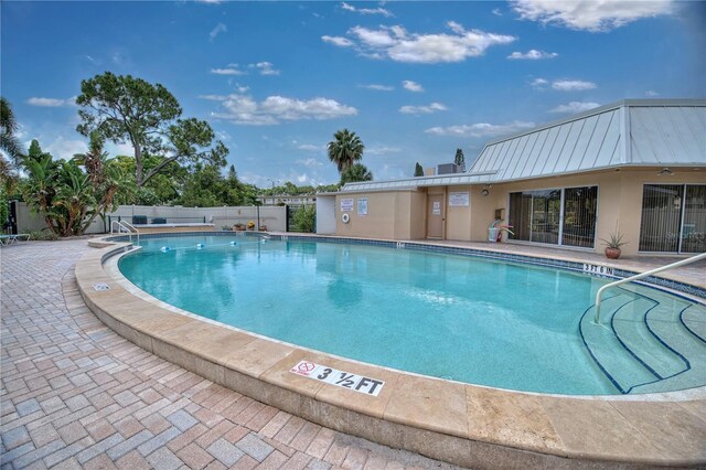 community pool featuring a patio area and fence