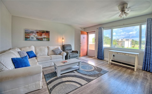 living room featuring wood-type flooring and ceiling fan