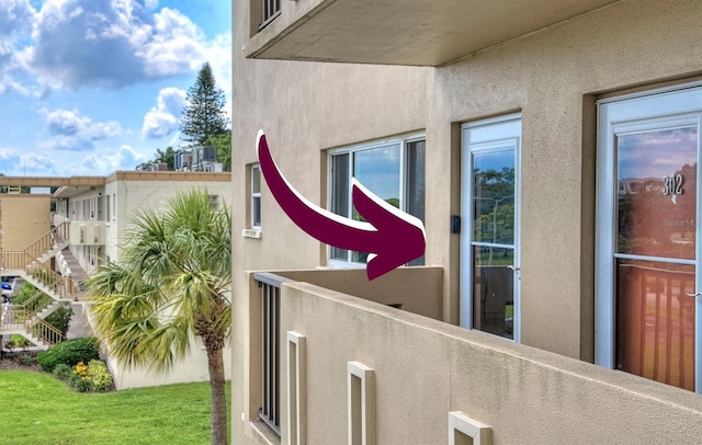 exterior details featuring fence and stucco siding