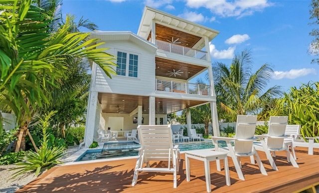 rear view of house featuring a patio, a balcony, ceiling fan, and a pool side deck