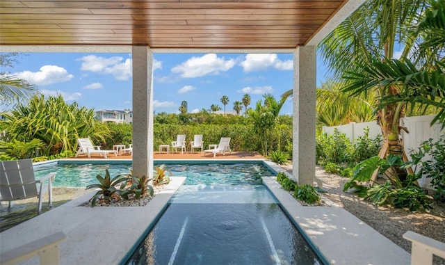 view of swimming pool with a hot tub