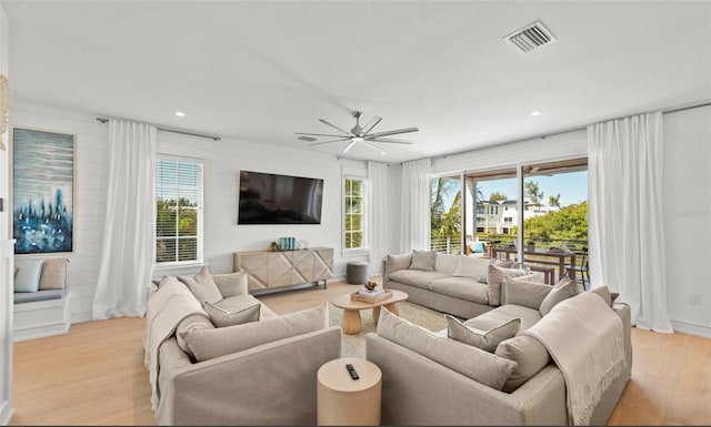 living room featuring ceiling fan and light wood-type flooring