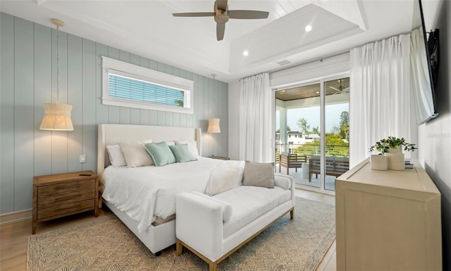 bedroom with light wood-type flooring, access to outside, and ceiling fan