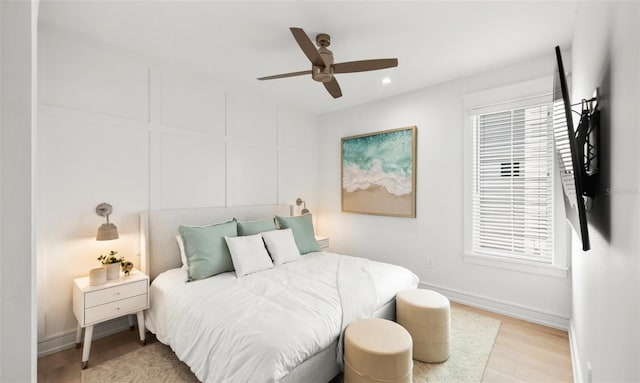 bedroom with ceiling fan and light hardwood / wood-style floors