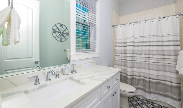 bathroom with a shower with curtain, tile patterned flooring, vanity, and toilet