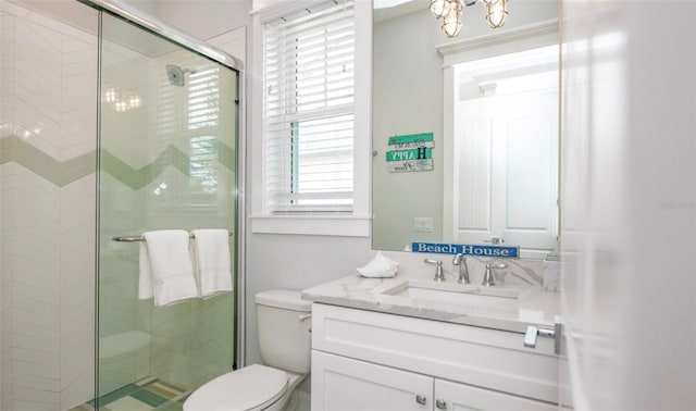 bathroom with vanity, an enclosed shower, and toilet