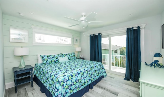 bedroom with ceiling fan, light hardwood / wood-style floors, access to outside, and multiple windows