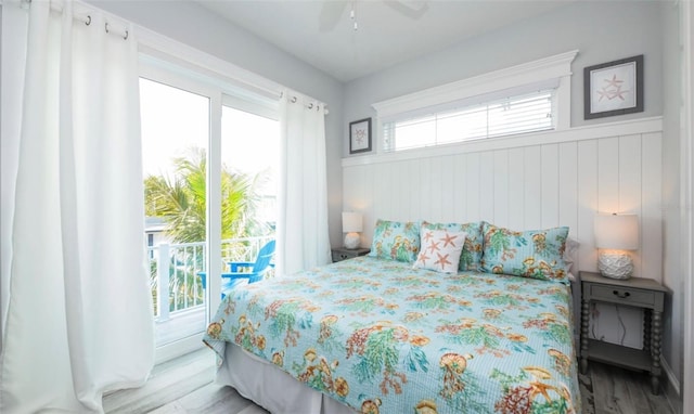 bedroom with access to outside, multiple windows, ceiling fan, and light hardwood / wood-style flooring