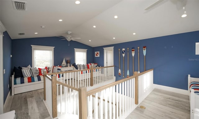 interior space with light hardwood / wood-style floors, vaulted ceiling, and ceiling fan