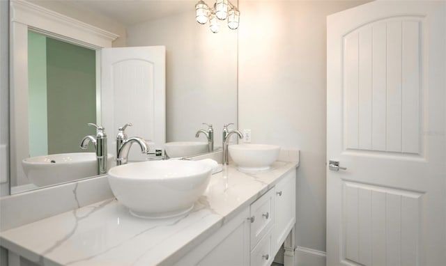 bathroom with vanity and a notable chandelier