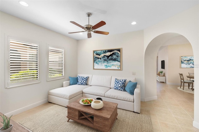 tiled living room featuring ceiling fan