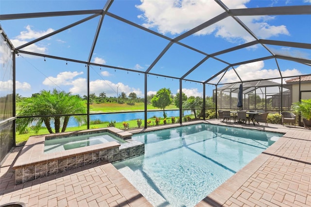 view of swimming pool with an in ground hot tub, a water view, glass enclosure, and a patio area