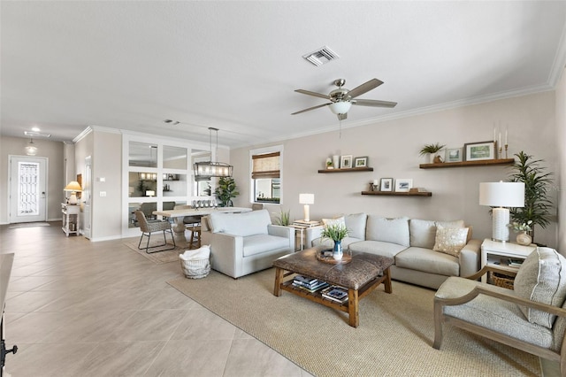 tiled living room featuring ceiling fan and crown molding